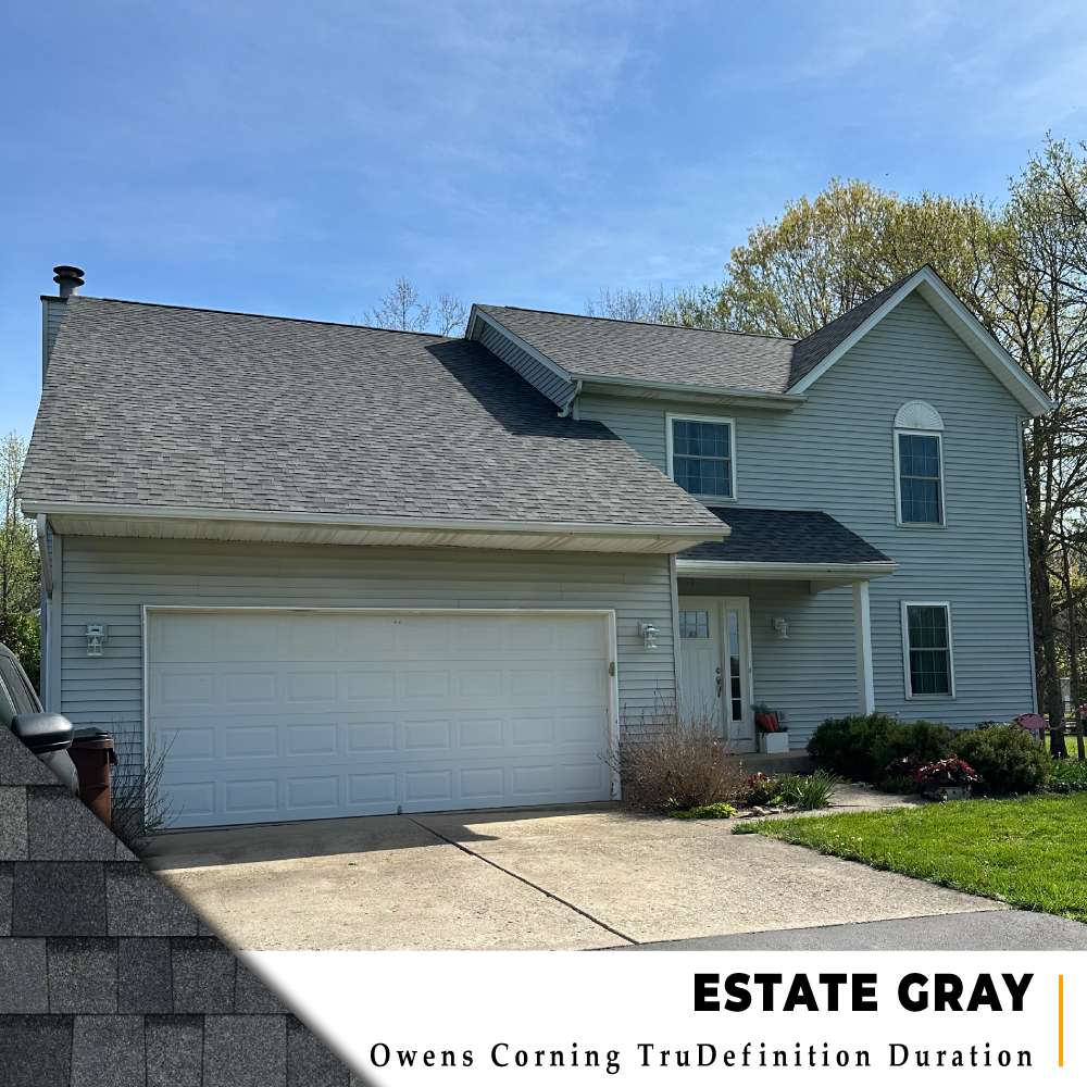New roof with Estate Gray dimensional shingles on a two-story blue siding home in Cincinnati, Ohio.