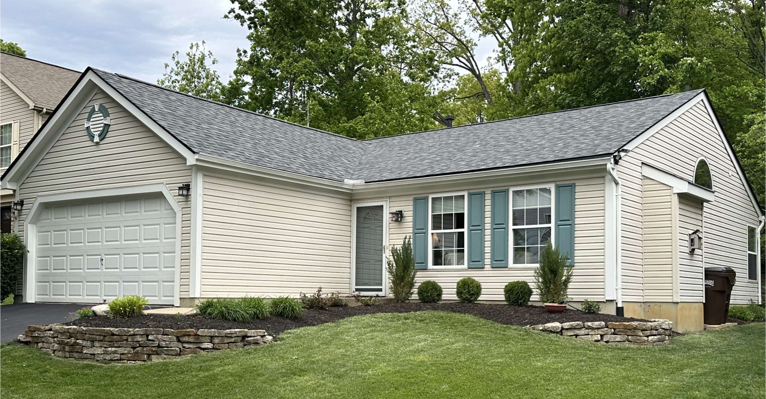 A charming and durable neutral-toned shingle roof installation by Weather Stop Roofing on a tan ranch home in Loveland, OH.